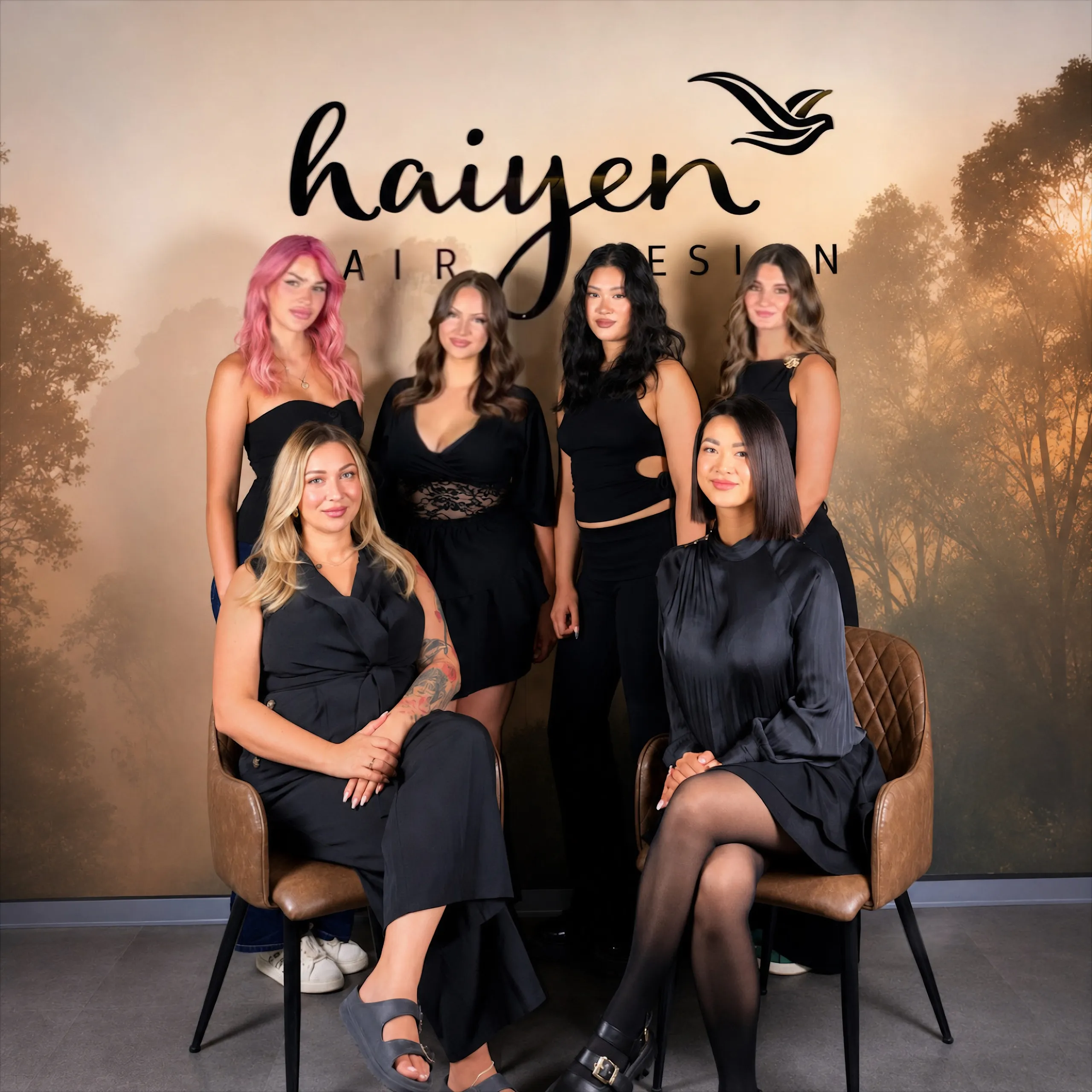 Das sechsköpfige Team von Haiyen Hairdesign in Dresden gemeinsam vor der Salonwand